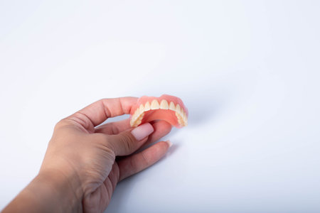render of mandibular prosthesis all on 4 system supported by implants over white backgroundの写真素材