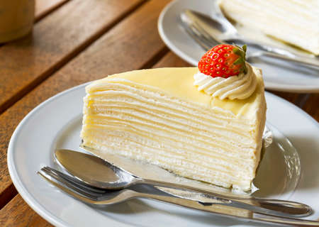 Delicious of strawberry crepe cake on wooden table, top viewの写真素材