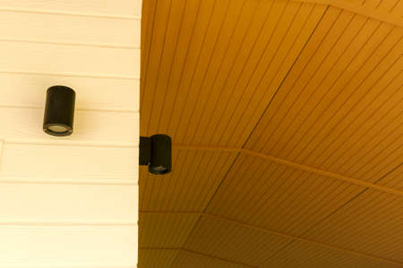 Modern electric lamp on yellow wallの写真素材