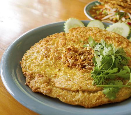 Ostrichâs omelette with fresh parsley on a plateの写真素材