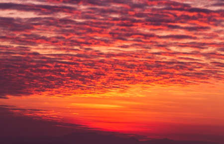 Beautiful and fiery orange sunset sky backgroundの写真素材