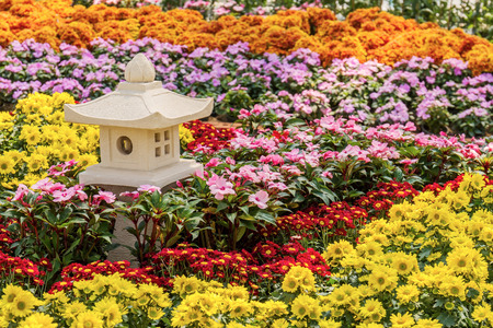 Japanese stone lantern house decorative in flower gardenの写真素材