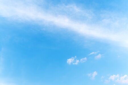 Fluffy white clouds flying on blue sky background