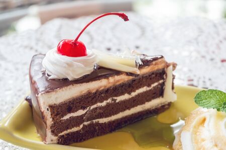 Cherry and chocolate cake on plate, close upの写真素材