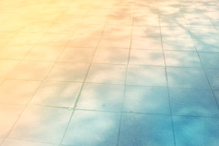 Concrete tiles floor with tree shade background - Color filter style picturesの写真素材