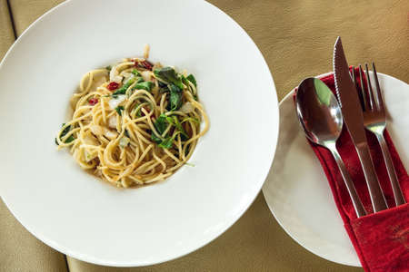 Top view of spicy spaghetti with silverware on food tableの写真素材