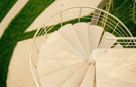 Top view of spiral stairway in rooftop ornamental garden in urban settingの写真素材