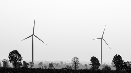 Wind turbines power generator on blue sky at farmer field - black and white colorの写真素材