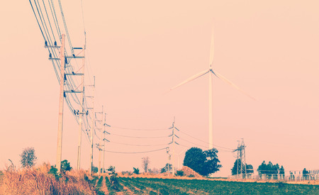 Wind turbines power generator on sky at farmer field - color filter effect style pictures
