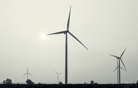 Wind turbines power generator on sky at farmer field - black and white style picturesの写真素材