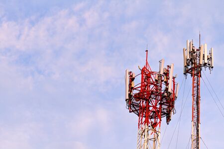 Mobile phone towers over white cloud and blue sky in rural areas