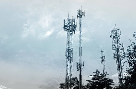 Mobile phone towers over cloud sky in rural areas - color filter effect style picturesの写真素材