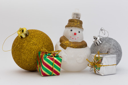 Silver and gold shiny Christmas balls with snowman and little gifts isolated on white backgroundの写真素材