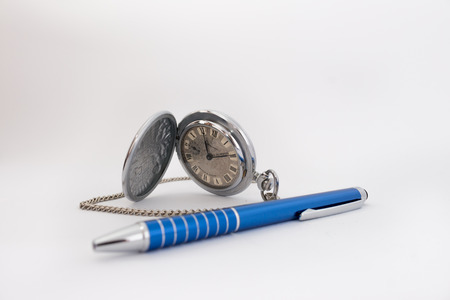 Vintage Pocket Watch with pen on white backgroundの写真素材