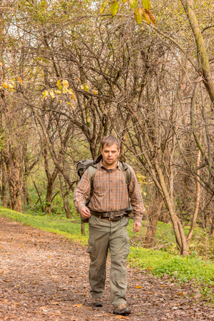 man walking in nature with backpackの写真素材