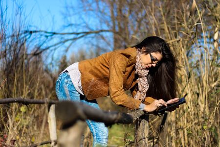 Woman with digital tablet in nature - love my jobの写真素材