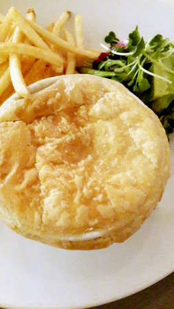 Chicken and mushroom pie with fries and salad on the side