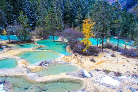 Huanglong National Park in the northwest part of Sichuan, China.known for its colorful pools formed by calcite deposits,as well as diverse forest ecosystems, snow-capped peaks, waterfalls and hot springs.の写真素材