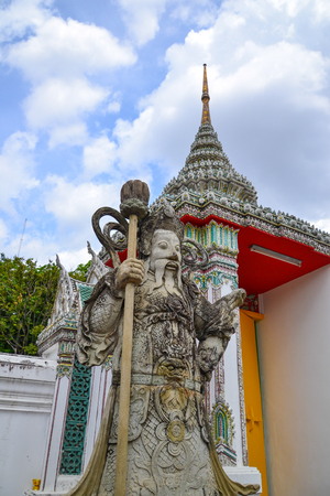 Chinese guardian figure at a gate in Wat Pho(Buddhist temple in Bangkok,Thailand)の写真素材