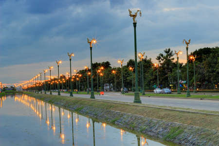 twilight sky at Thanon Utthayan(Aksa Road), Bangkok,Thailand-one of the most beautiful roads in Thailand. Along both sides of the road are 979 lamp posts decorated with the Thai phoenixのeditorial素材