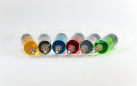 plastic syringes containing multicolor solutionsの写真素材