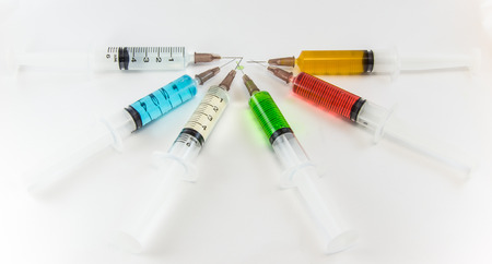 plastic syringes containing multicolor solutionsの写真素材