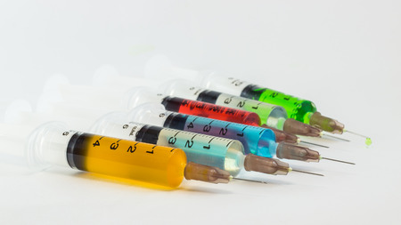 plastic syringes containing multicolor solutionsの写真素材