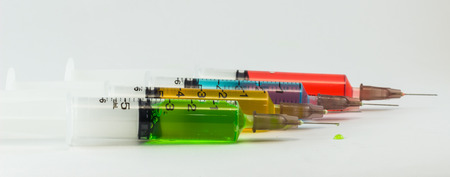plastic syringes containing multicolor solutionsの写真素材