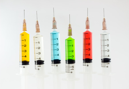 plastic syringes containing multicolor solutionsの写真素材