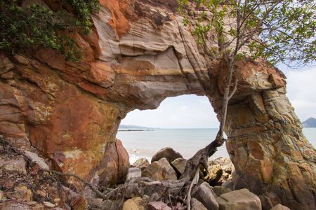 Natural hole on colorful rocks at Laem Chamuk Khwai in Khao Thong,Mueang Krabi District,Krabi province,southern Thailand.の写真素材