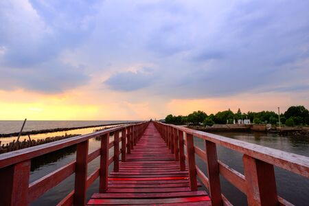 Sunset sky at red wooden bridge near Matchanu Shrine,Samut Sakhon,Thailand.の写真素材