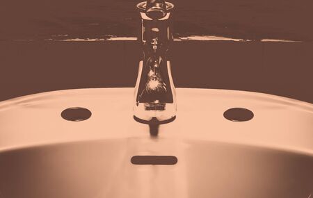 Wash basin and the tap look like a human face.の写真素材