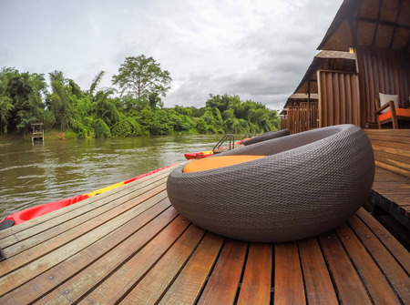 Cozy atmosphere and natural touch along Kwai Noi River,Sai Yok,Kanchanaburi,Thailand.With sofa bed on the balcony of the raft house.のeditorial素材