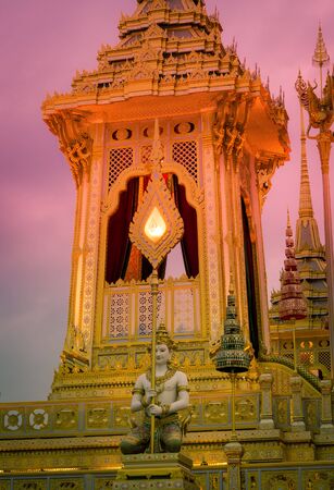 Exhibition on royal cremation ceremony of His Majesty King Bhumibol Adulyadej,Sanam Luang Ceremonial Ground,Bangkok,Thailand on November7,2017:Kneeling deities carrying fan-shaped regalia at Royal Crematoriumのeditorial素材