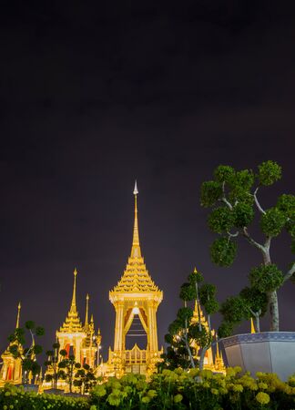 Exhibition on royal cremation ceremony of His Majesty King Bhumibol Adulyadej,Sanam Luang Ceremonial Ground,Bangkok,Thailand on November7,2017:Royal Crematorium with Marigold flowers in the foregroundのeditorial素材