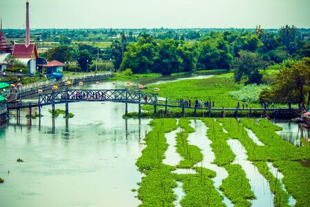 Suphanburi, Thailand - December 15, 2018 : 100 Year Arch Bridge of Thong Pradit Temple as the entrance to the market.のeditorial素材