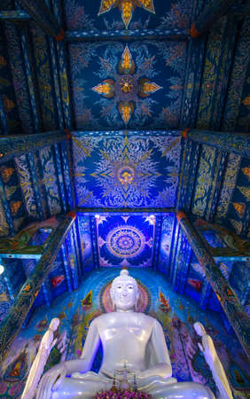 Rimkok district, Chiang Rai Province, Northern Thailand on January 19, 2020: Large white Buddha image in subduing Mara at Wat Rong Suea Ten or Blue Temple.のeditorial素材
