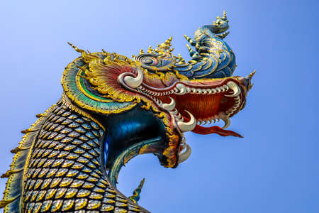 Rimkok district,Chiang Rai Province,Northern Thailand on January 19,2020:Colorful naga flank the balustrade,acting as guards to the main hallâs entrance of Wat Rong Suea Ten or Blue Temple.のeditorial素材