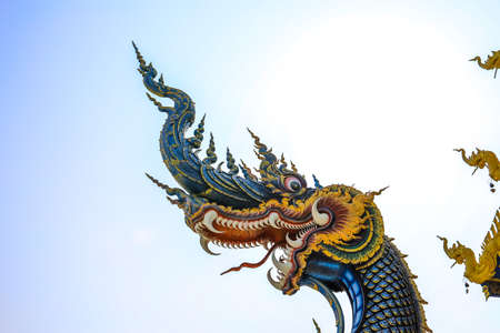Rimkok district,Chiang Rai Province,Northern Thailand on January 19,2020:Colorful naga flank the balustrade,acting as guards to the main hallâs entrance of Wat Rong Suea Ten or Blue Temple.のeditorial素材