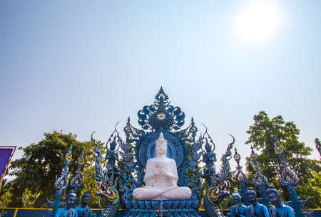 Rimkok district,Chiang Rai Province,Northern Thailand on January 19,2020:White Buddha statue and disciples of Lord Buddha at Wat Rong Suea Ten or Blue Temple.(selective focus)のeditorial素材