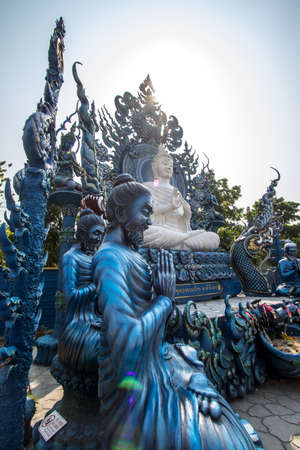 Rimkok district,Chiang Rai Province,Northern Thailand on January 19,2020:White Buddha statue and disciples of Lord Buddha at Wat Rong Suea Ten or Blue Temple.(selective focus)のeditorial素材
