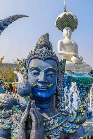 Rimkok district,Chiang Rai Province,Northern Thailand on January 19,2020:The fountain,white Buddha statue and angellic guardians in front of the main hall of Wat Rong Suea Ten or Blue Temple.(selective focus)のeditorial素材