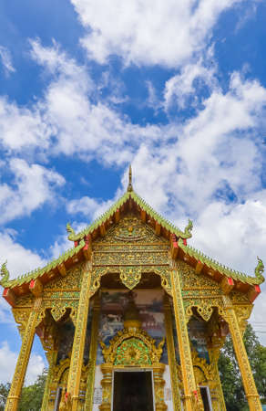 Mae Hia sub district,Chiang Mai province,Northern Thailand on Septemmber 13,2019:Lanna style ubosot or ordination hall of Wat Phra That Doi Kham is a very ornate structure with a multi tiered roof and Naga barge boards.のeditorial素材