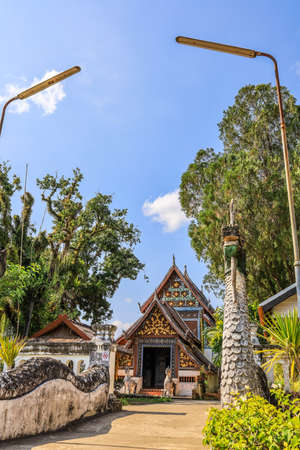 Tha Wang Pha District,Nan Province,Northern Thailand on December 20,2019:Old sculptured Nagas at the gate of Wat Nong Bua.The vihara(main hall) is in the distance.のeditorial素材