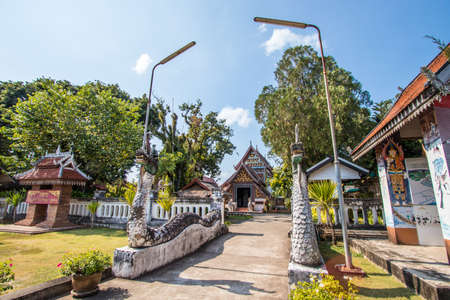 Tha Wang Pha District,Nan Province,Northern Thailand on December 20,2019:Old sculptured Nagas at the gate of Wat Nong Bua.The vihara(main hall) is in the distance.のeditorial素材