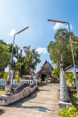 Tha Wang Pha District,Nan Province,Northern Thailand on December20,2019:Old sculptured Nagas at the gate of Wat Nong Bua.The vihara(main hall) is in the distance.のeditorial素材