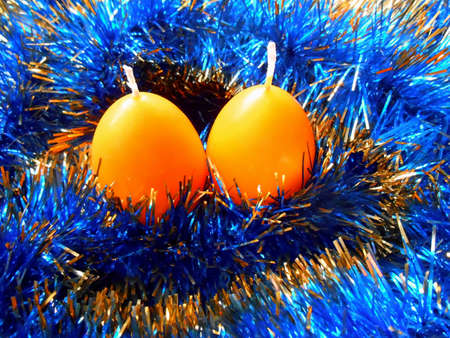 Christmas and New Year two candles yellow on blue  backgroundの写真素材