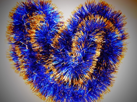 Christmas and New Year blue and gold tinsel heart backgroundの写真素材