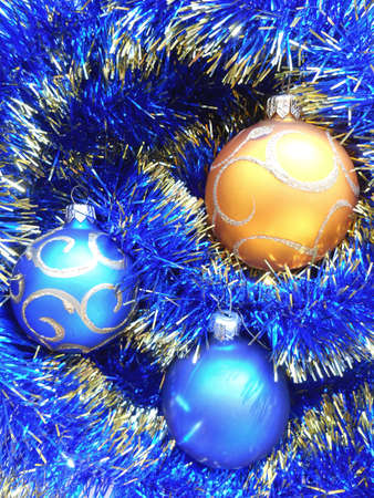 Christmas and New Year decoration balls on a blue tinsel backgroundの写真素材