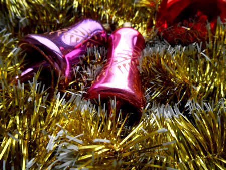 Christmas and New Year decoration bells on a golden backgroundの写真素材
